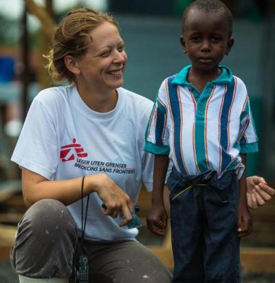 MSF woman standing with young boy